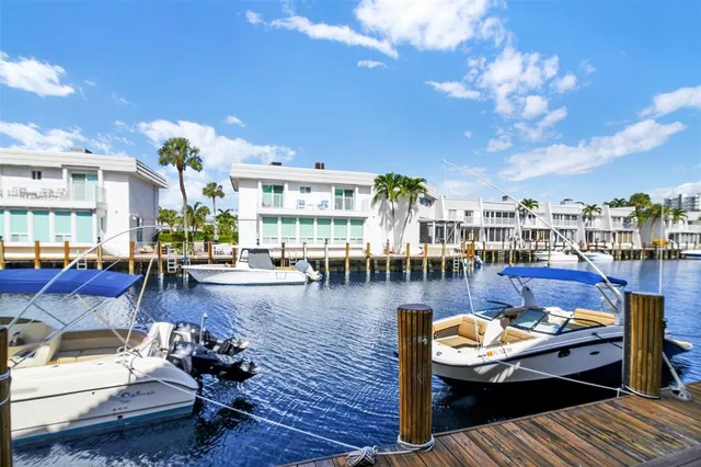 a view of a patio with dining table and chairs with wooden floor