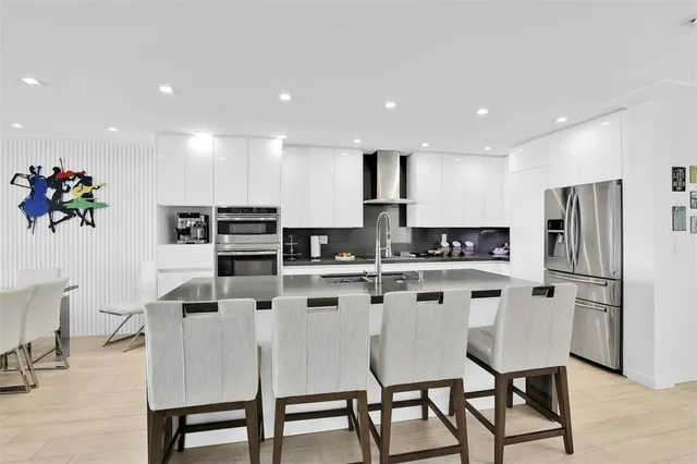 a white toilet sitting next to a white wall