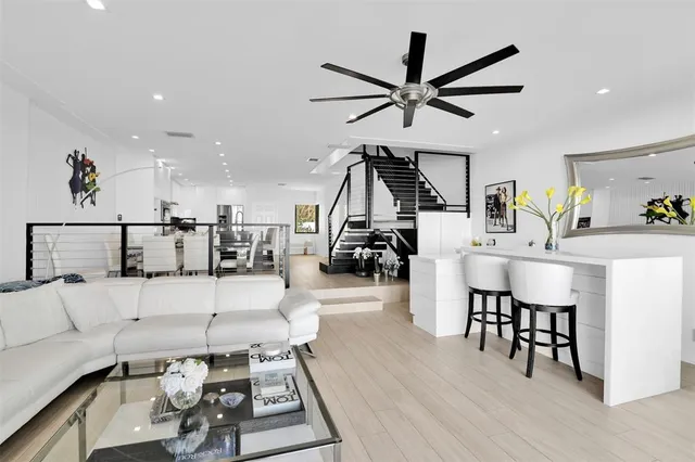 a kitchen with stainless steel appliances kitchen island granite countertop a table and chairs