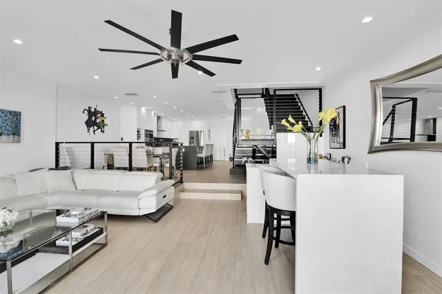 a living room with furniture and kitchen view