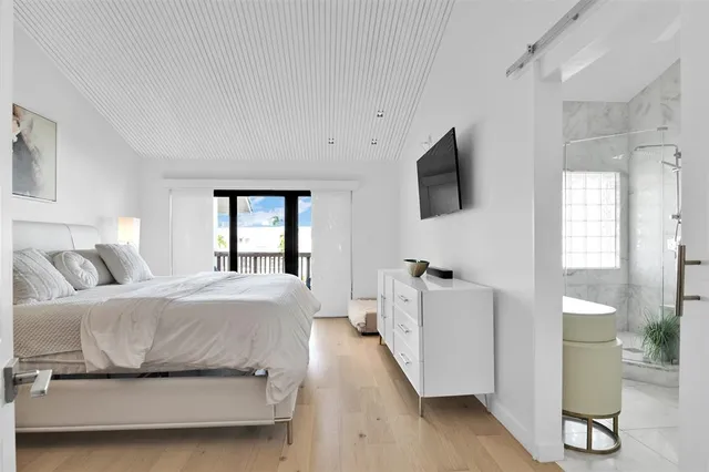 a bedroom with a bed and a painting on the wall