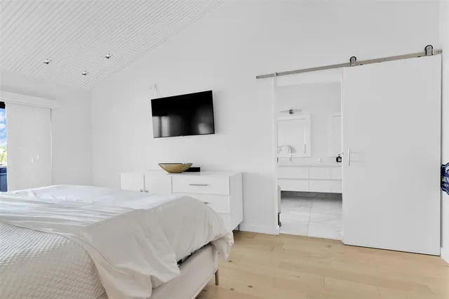 a bedroom with a bed and a television