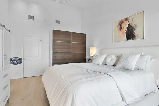 a bathroom with a double vanity sink mirror and bathtub