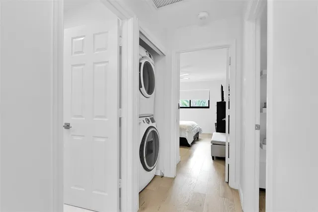 a bedroom with bed and a painting on the wall