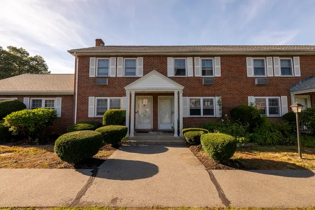 a front view of a house with yard and porch