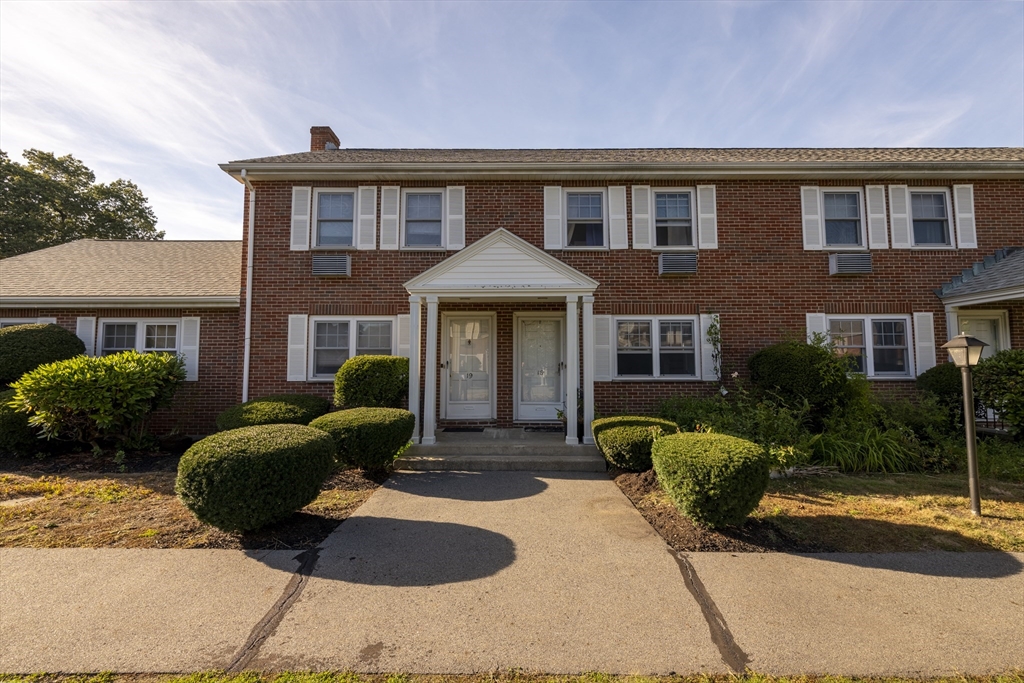 a front view of a house with yard and porch