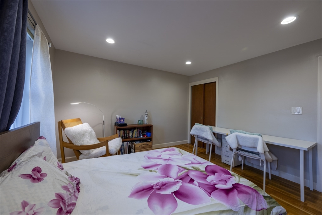 18 Emerson Gardens Road, Unit 18 Lexington, MA 02420 - Photo 11 of 23 a bedroom with furniture and a wooden floor