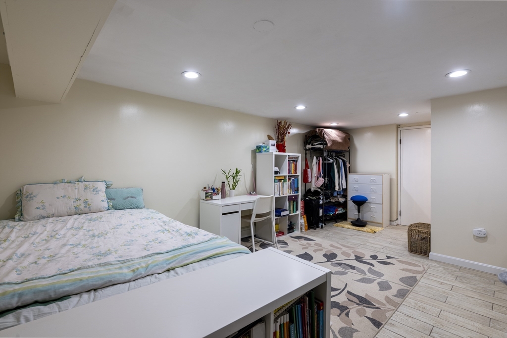 18 Emerson Gardens Road, Unit 18 Lexington, MA 02420 - Photo 15 of 23 a bedroom with a bed and a large mirror