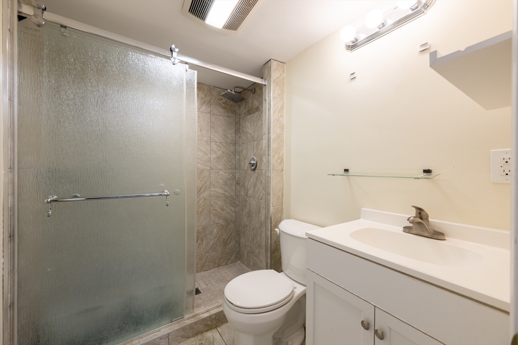 18 Emerson Gardens Road, Unit 18 Lexington, MA 02420 - Photo 17 of 23 a bathroom with a sink a toilet and shower