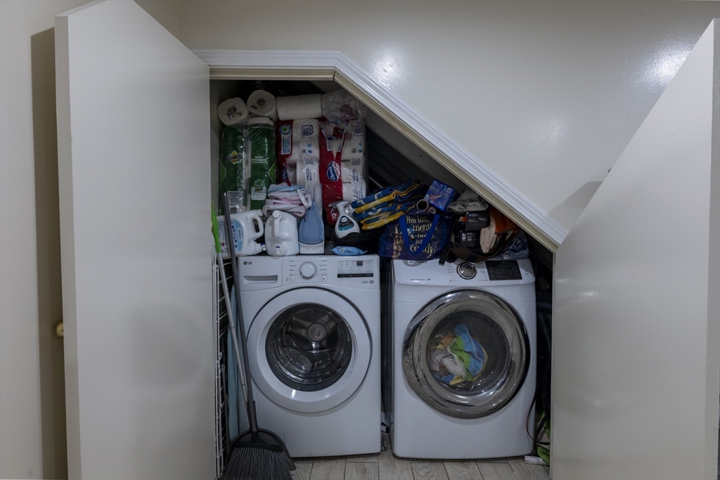 18 Emerson Gardens Road, Unit 18 Lexington, MA 02420 - Photo 18 of 23 a view of a storage & utility room with washer and dryer
