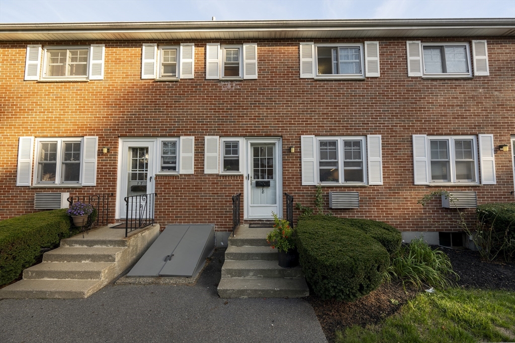 18 Emerson Gardens Road, Unit 18 Lexington, MA 02420 - Photo 20 of 23 a front view of a house with a garden