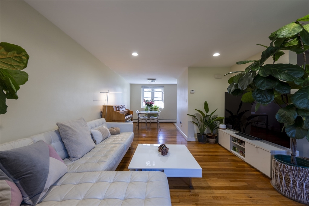 18 Emerson Gardens Road, Unit 18 Lexington, MA 02420 - Photo 2 of 23 a living room with furniture and a potted plant