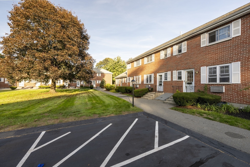 18 Emerson Gardens Road, Unit 18 Lexington, MA 02420 - Photo 21 of 23 a view of building with yard