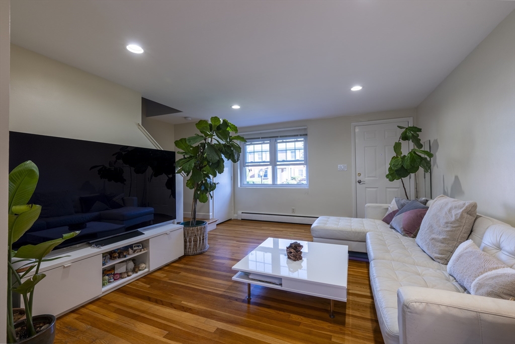 18 Emerson Gardens Road, Unit 18 Lexington, MA 02420 - Photo 3 of 23 a living room with furniture and a flat screen tv