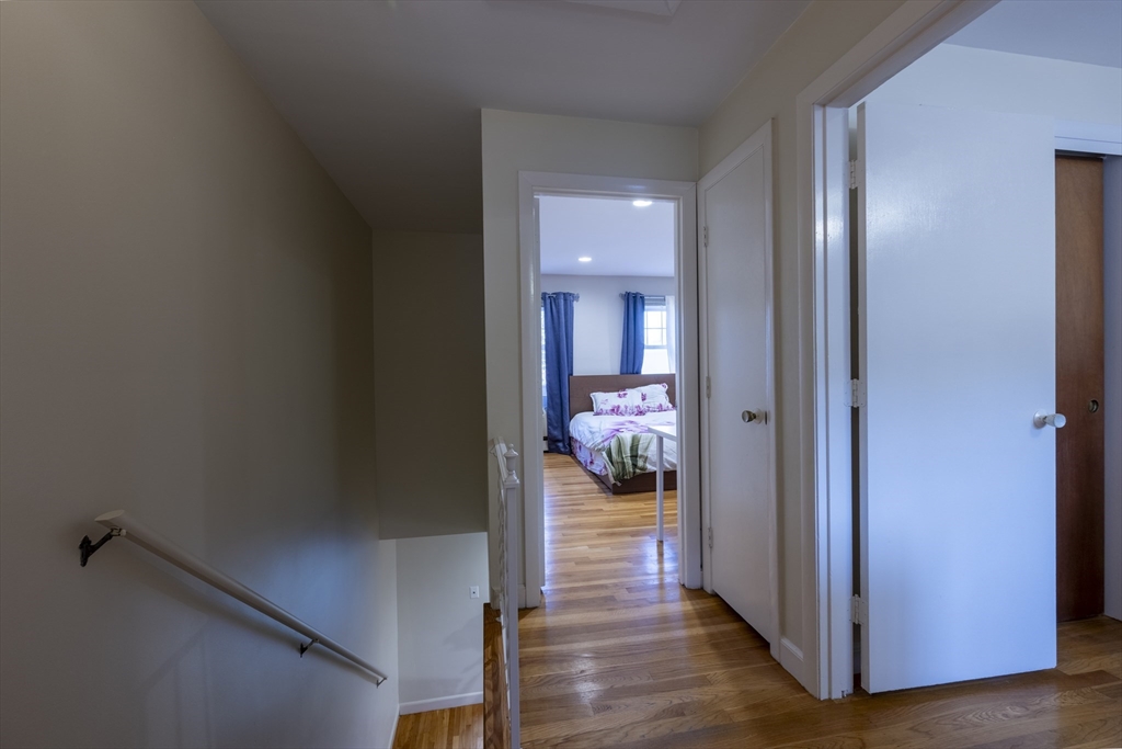 18 Emerson Gardens Road, Unit 18 Lexington, MA 02420 - Photo 8 of 23 a view of a room that has a bed and a large closet in it