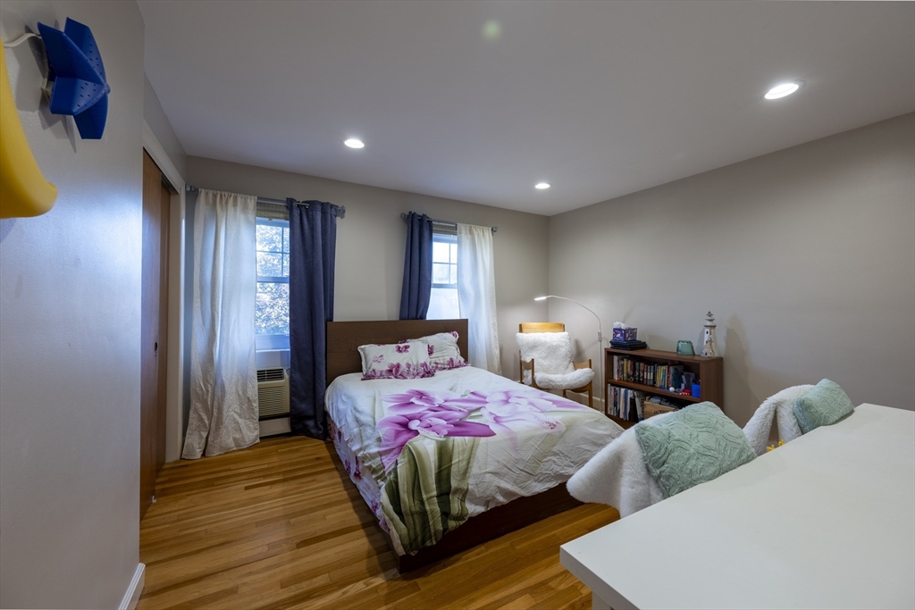 18 Emerson Gardens Road, Unit 18 Lexington, MA 02420 - Photo 9 of 23 a bedroom with two beds and painted walls