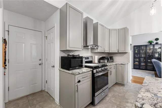 a view of a kitchen with electric appliances