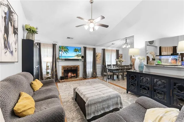 a living room with furniture and a fireplace