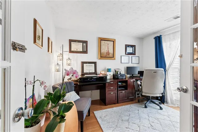 a view of a workspace with furniture and a potted plant