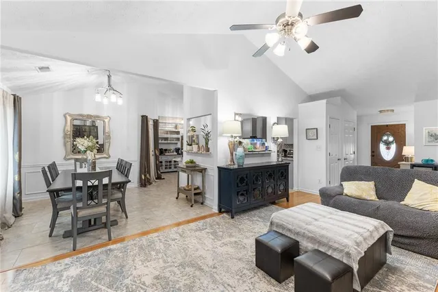 a living room with furniture and kitchen view