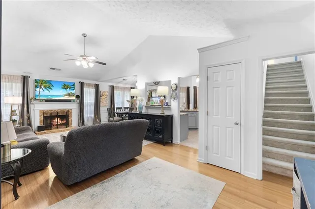 a living room with furniture a fireplace and a chandelier