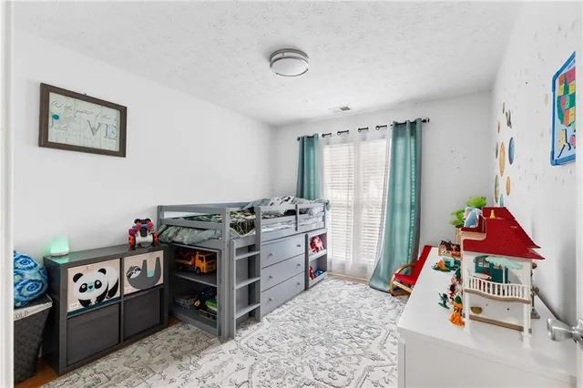 a view of a livingroom with fridge stove and a window