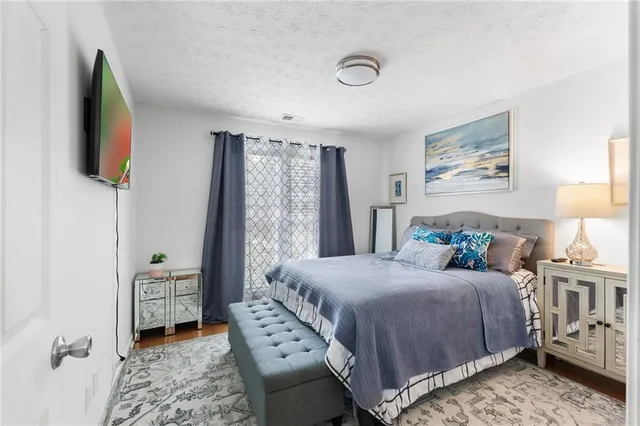 a bedroom with a bed and a tv