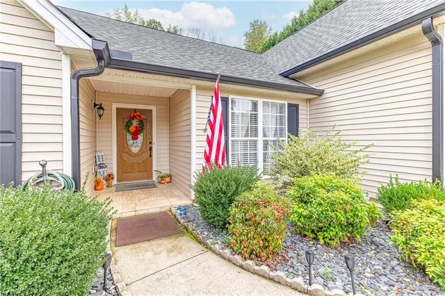 a front view of a house with garden