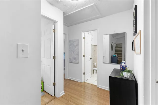 a view of a hallway with wooden floor and staircase