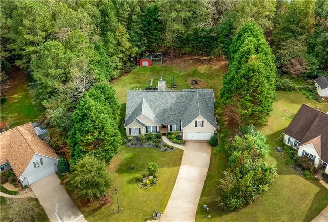 an aerial view of house with yard swimming pool and outdoor seating