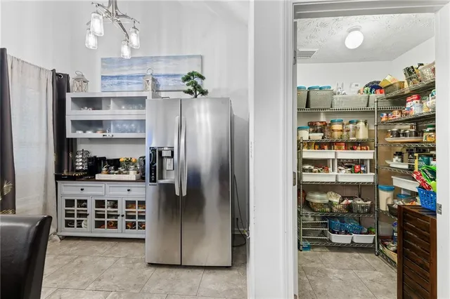 a kitchen with stainless steel appliances a refrigerator and a stove top oven