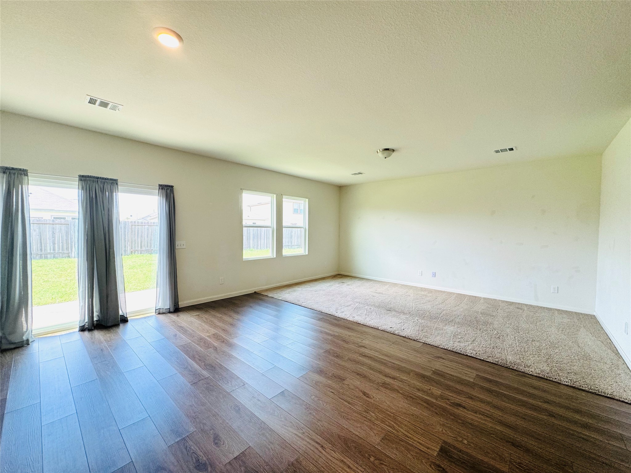 1013 Pitch Pine Brookshire, TX 77423 - Photo 11 of 30 a view of an empty room with window and wooden floor