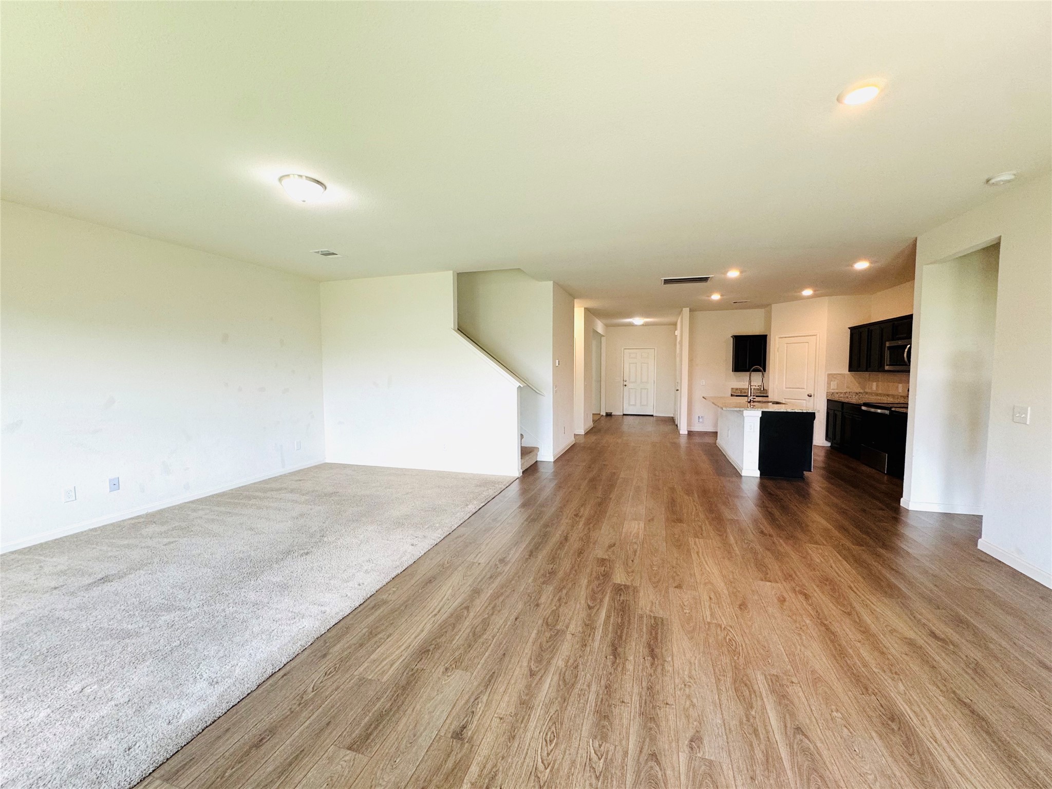 1013 Pitch Pine Brookshire, TX 77423 - Photo 12 of 30 a view of kitchen and hall with wooden floor