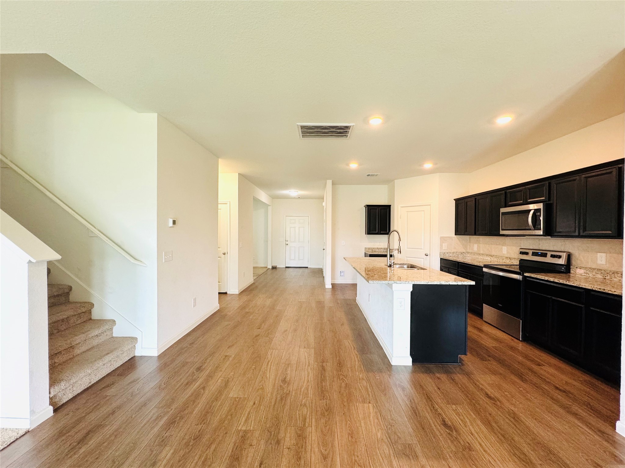 1013 Pitch Pine Brookshire, TX 77423 - Photo 9 of 30 a view of kitchen with microwave stove refrigerator and cabinets