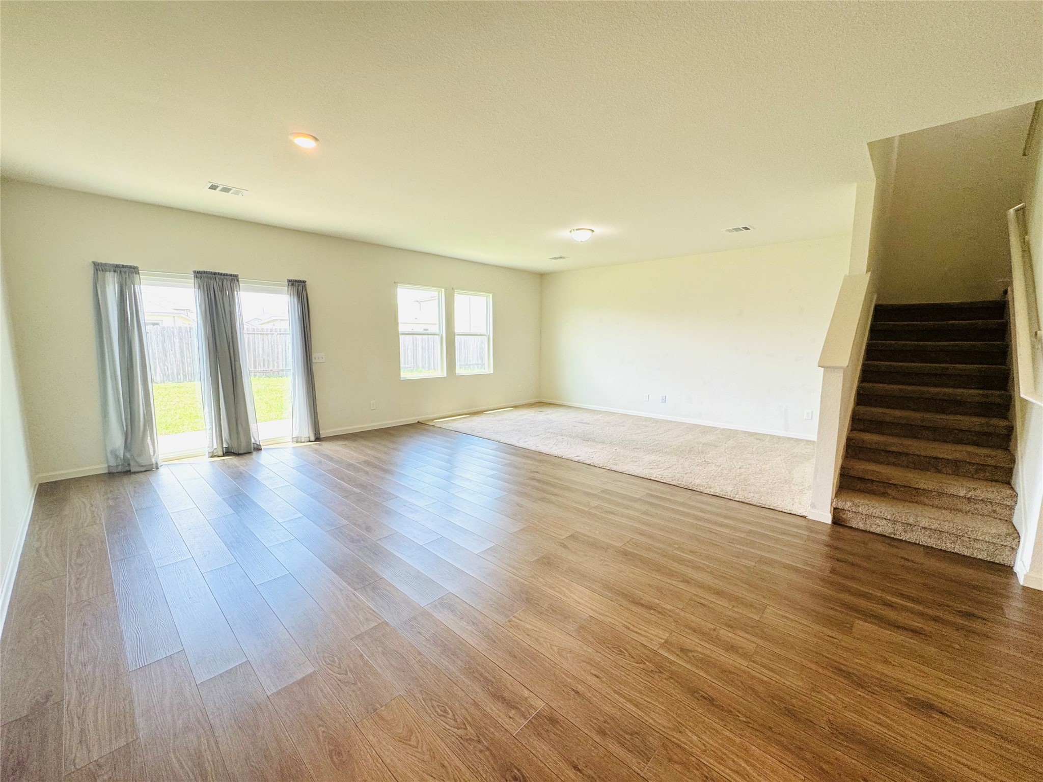 1013 Pitch Pine Brookshire, TX 77423 - Photo 10 of 30 a view of an empty room with wooden floor and stairs