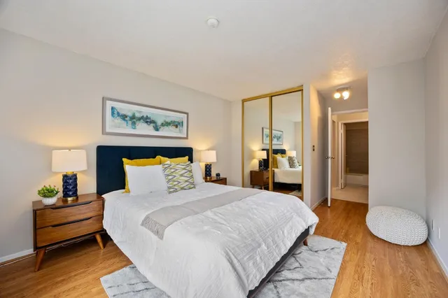 a bedroom with a bed and wooden floor