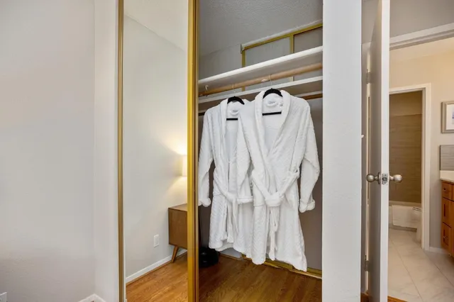 a view of walk in closet with clothes