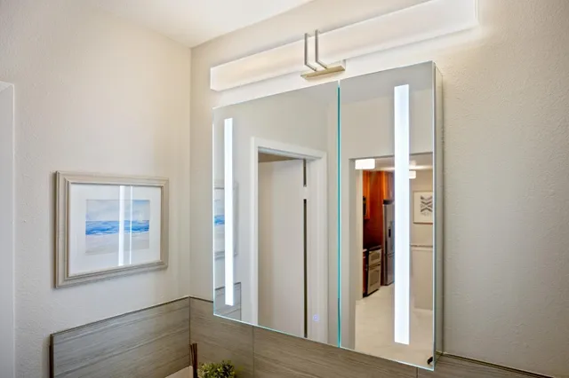 a view of a hallway with windows and chandelier