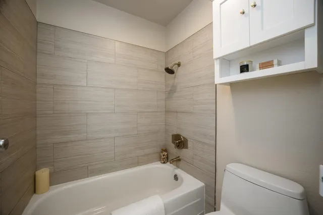 a bathroom with a bathtub and a toilet