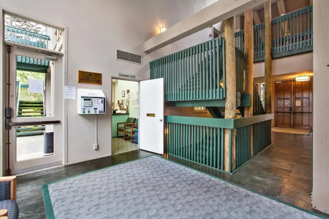 a room with pool table and windows