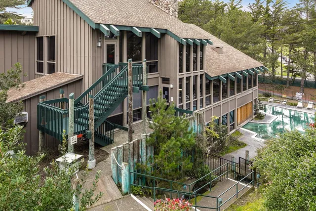 a view of a house with brick walls and flower plants