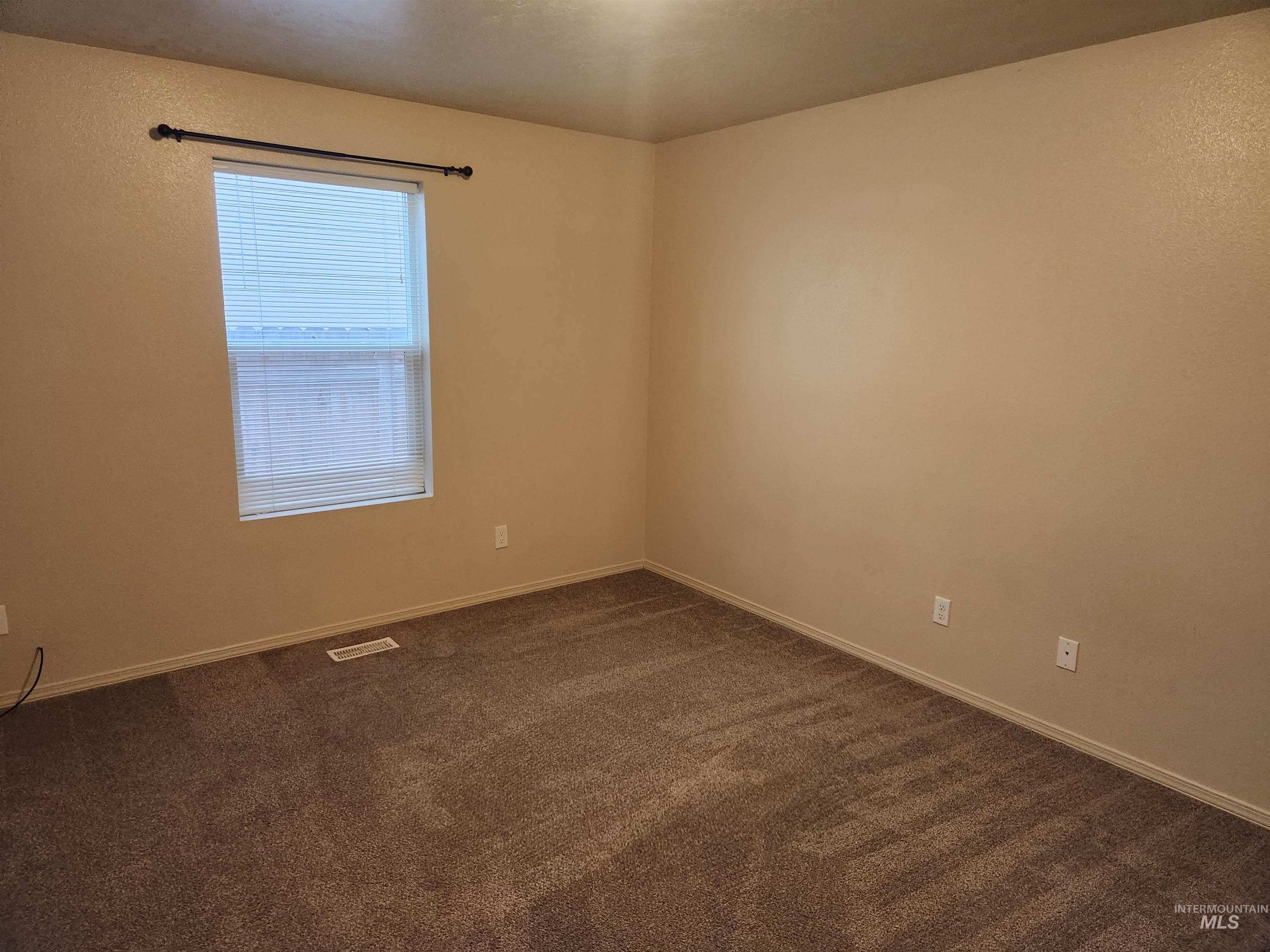 9962 West Rustica Street Boise, ID 83709 - Photo 6 of 15 Empty room featuring dark carpet