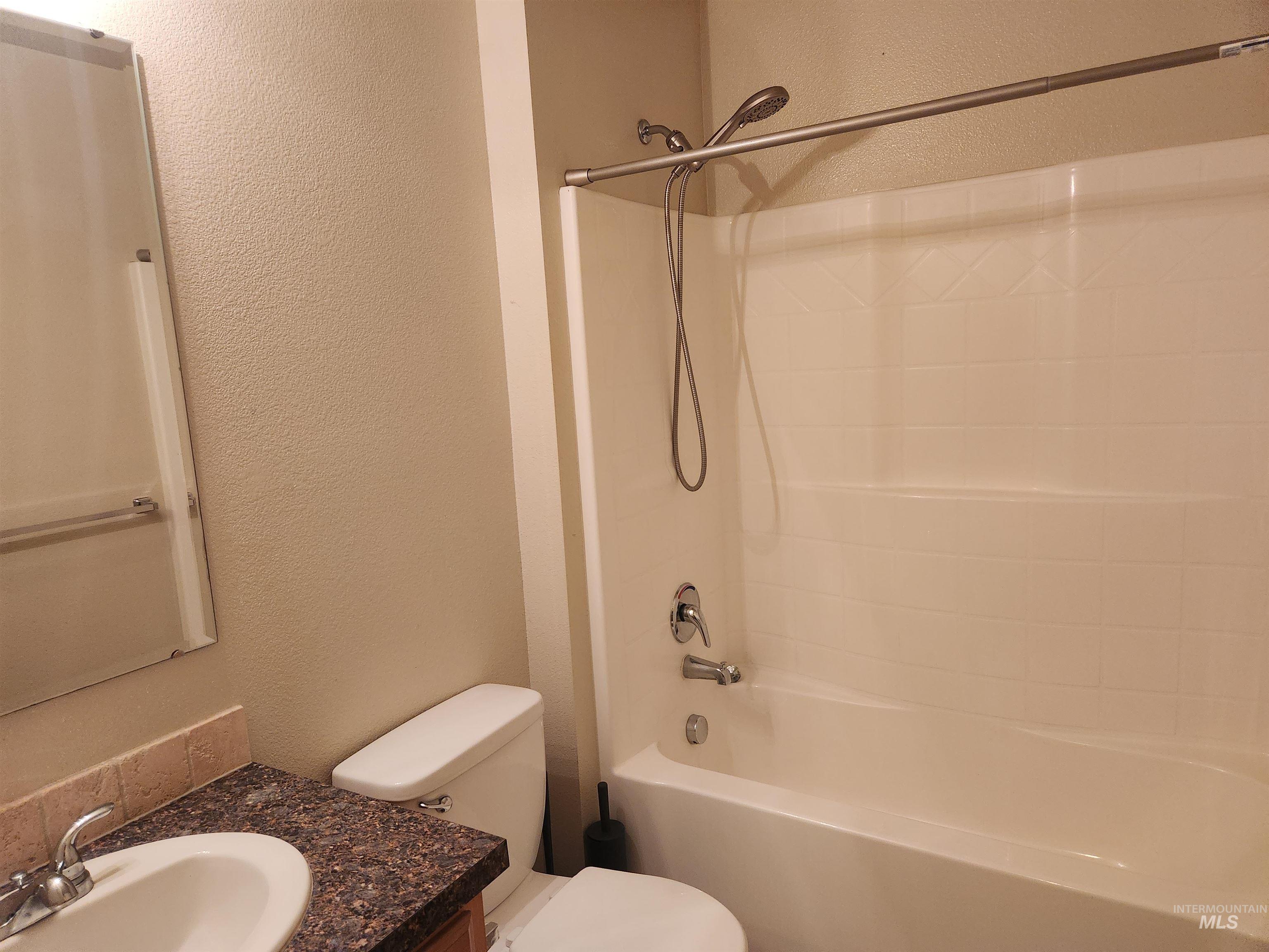 9962 West Rustica Street Boise, ID 83709 - Photo 7 of 15 Full bathroom featuring a textured wall, vanity, and shower / tub combination