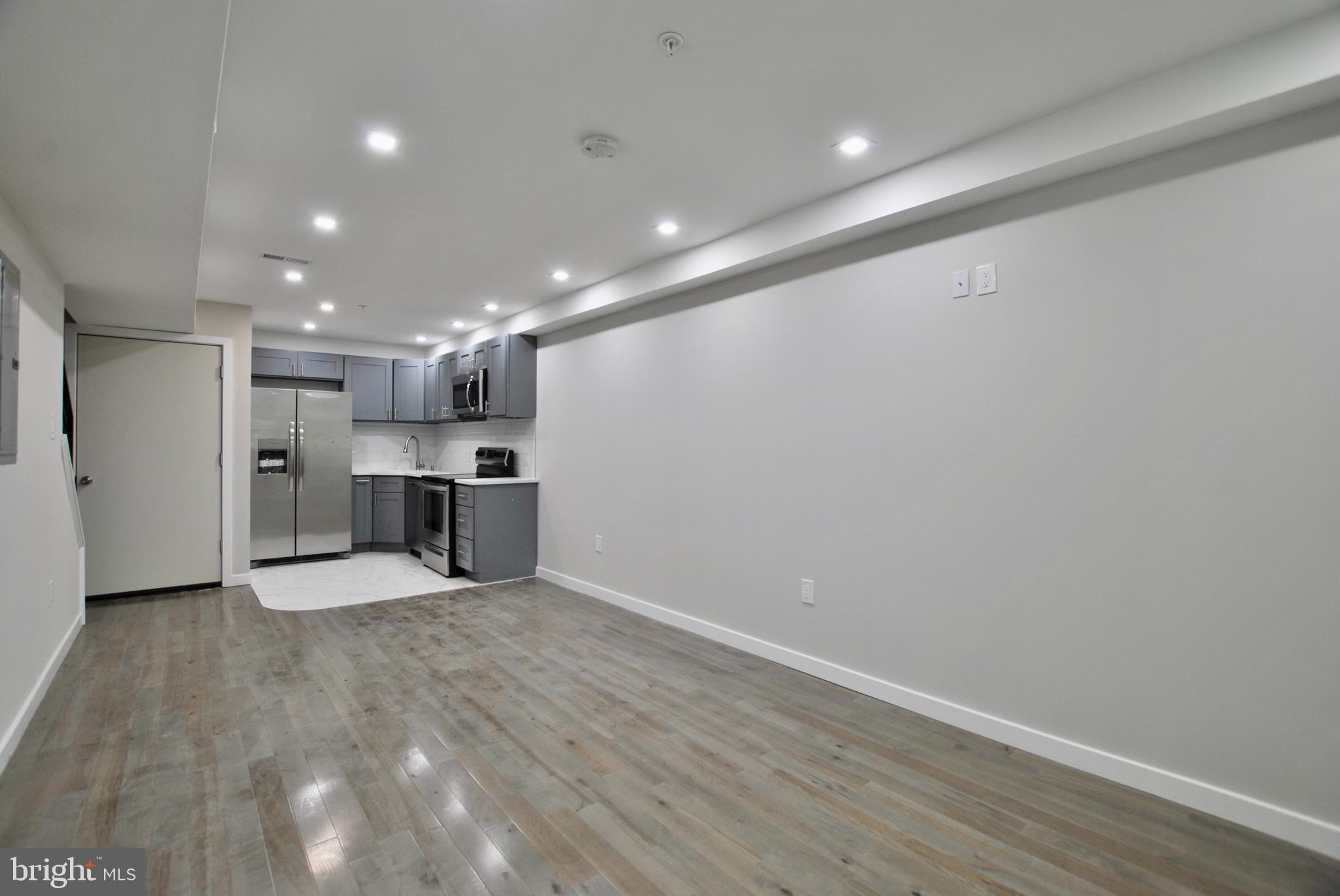 2153 North 19th Street, Unit 4 Philadelphia, PA 19121 - Photo 1 of 17 a view of kitchen with kitchen island wooden floor center island and stainless steel appliances