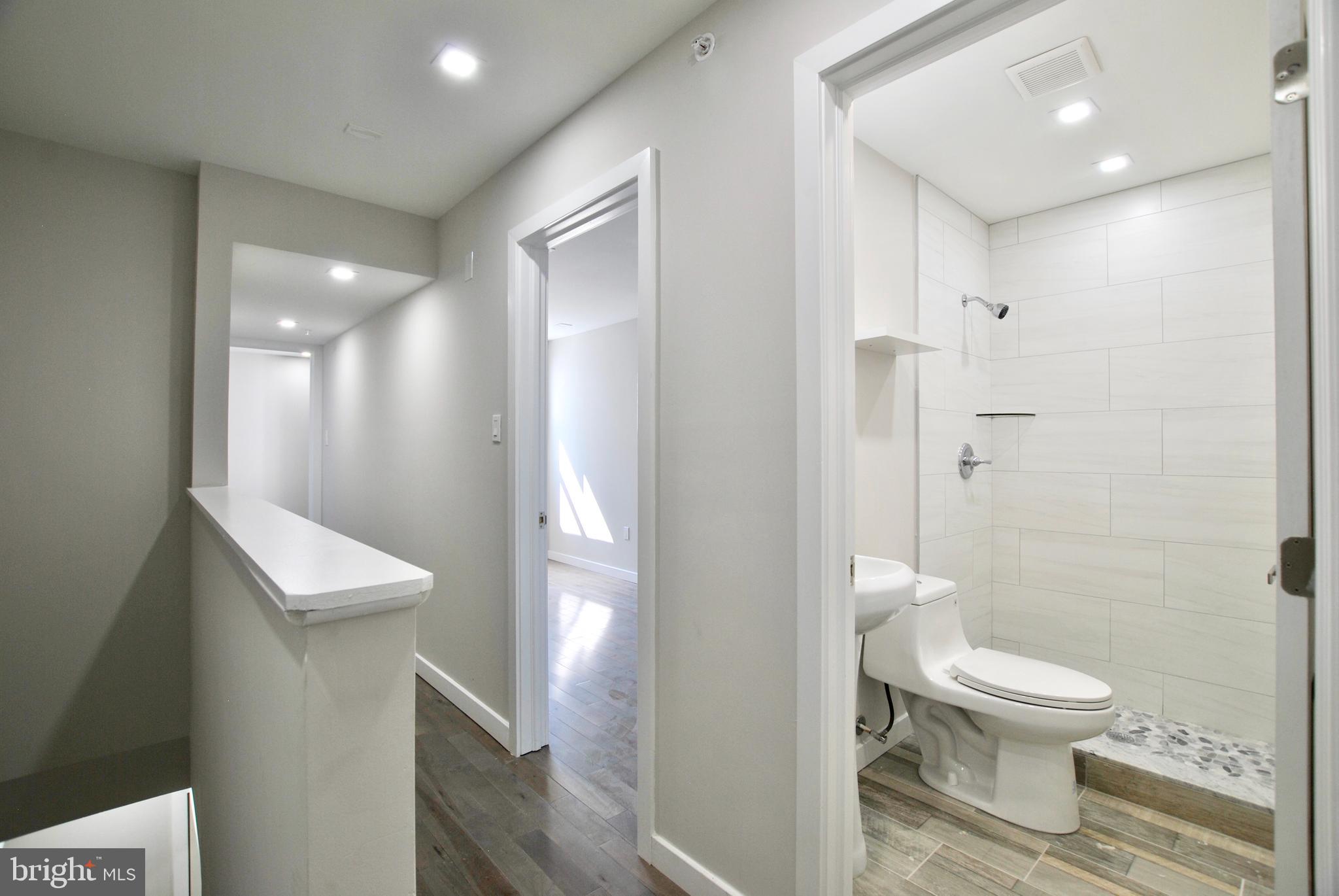 2153 North 19th Street, Unit 4 Philadelphia, PA 19121 - Photo 16 of 17 a bathroom with a toilet a sink and shower