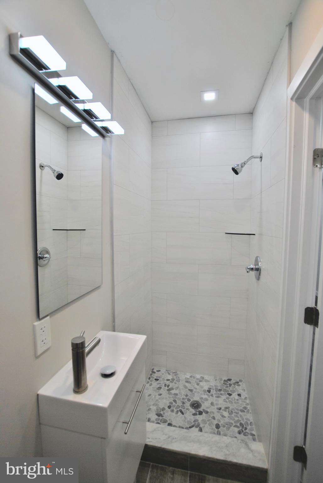 2153 North 19th Street, Unit 4 Philadelphia, PA 19121 - Photo 17 of 17 a bathroom with a sink and shower