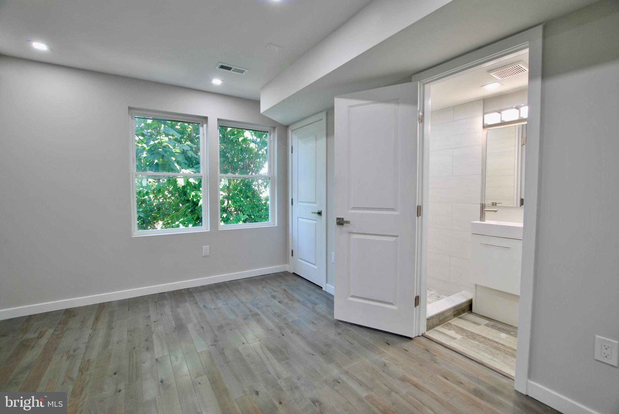 2153 North 19th Street, Unit 4 Philadelphia, PA 19121 - Photo 6 of 17 an empty room with wooden floor and windows