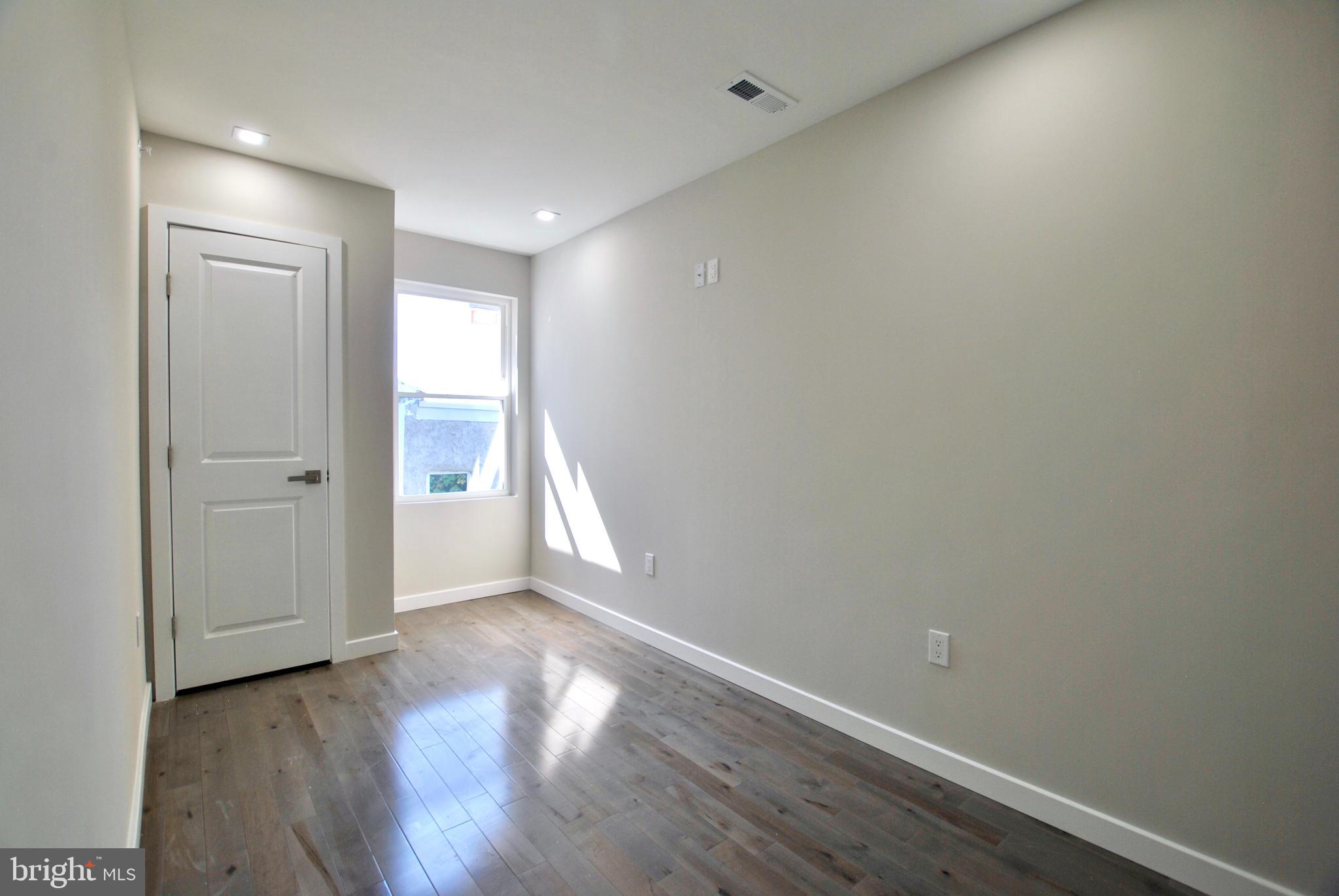 2153 North 19th Street, Unit 4 Philadelphia, PA 19121 - Photo 7 of 17 wooden floor in an empty room