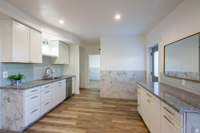 868 Braddock Lane Alpine, UT 84004 - Photo 44 of 64 Kitchen featuring white cabinetry with gold-toned hardware, granite countertops, and a blue penny tile backsplash