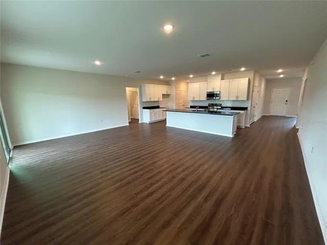 a view of kitchen with kitchen island microwave and stove
